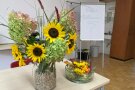 Blumen vor dem Begrüßungs-Flipchart